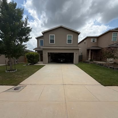 Recently pressure-washed residential driveway in New Braunfels
