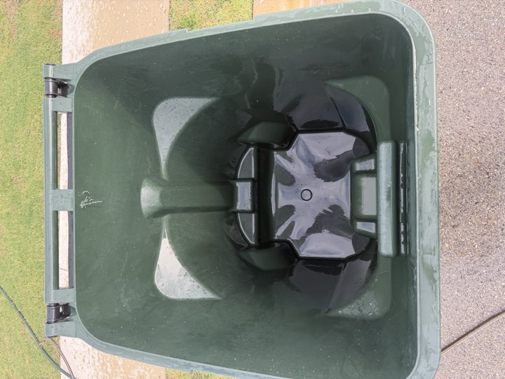 A second green trash bin interior after cleaning